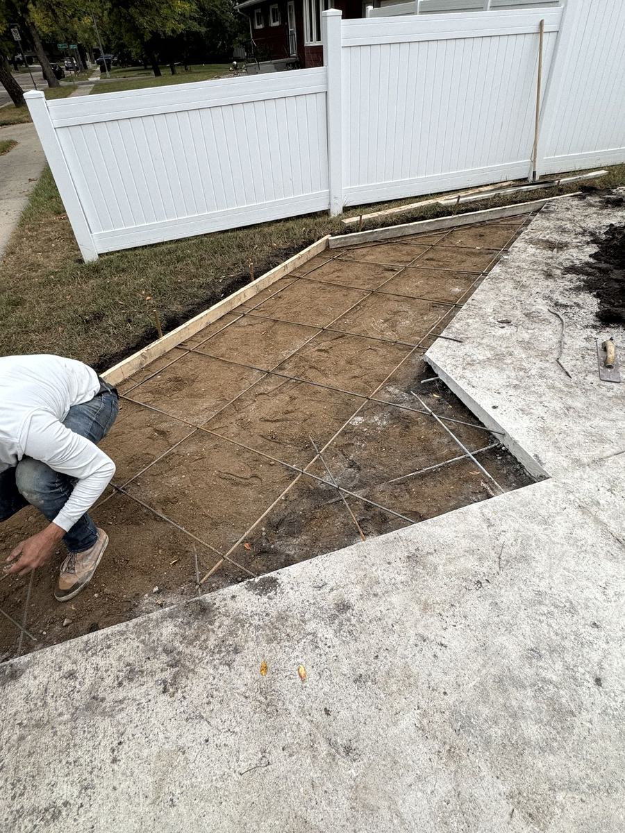 Broken-up driveway area prepped for new concrete