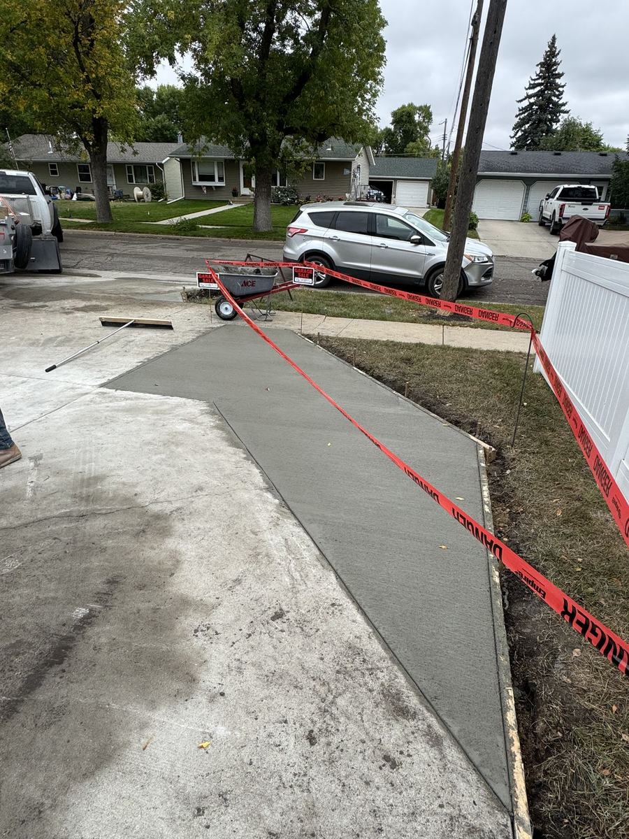 Curved concrete walkway poured by OARA