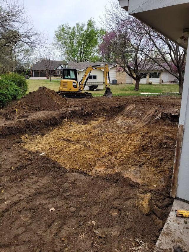 Compact CAT excavator grading a residential backyard, by OARA near Fargo, ND