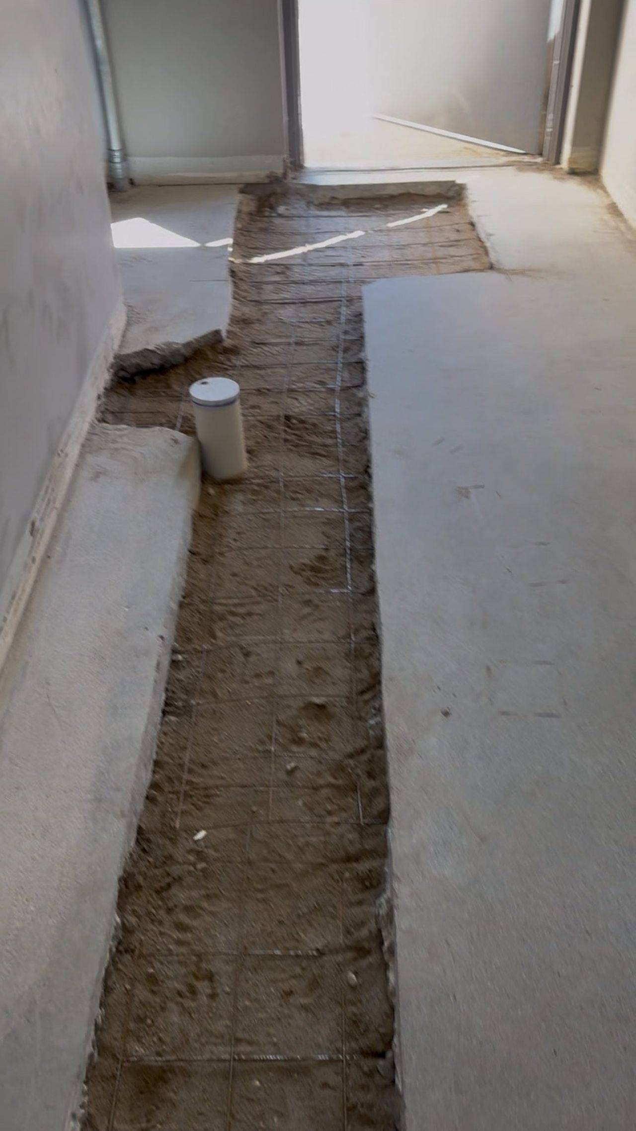 Trench saw-cut into a concrete slab for new plumbing, by OARA in Fargo, ND